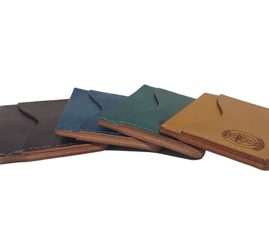 Minimalist Card Wallet - Hand-Dyed Made from Hand-dyed Vegtan Leather Designed to carry just your most important bank cards, credit cards and ID. Features 2 outside pockets, and one interior pocket. All hand-stitched.